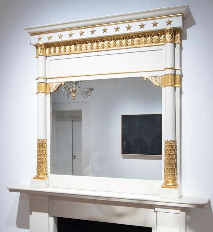 A neoclassical gilt and lacca mantel mirror
